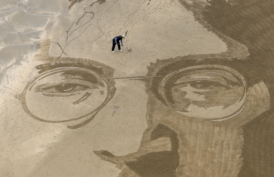 Dibujo en la arena del cantante británico John Lennon, obra del artista peruano Germán Cedano. /EFE